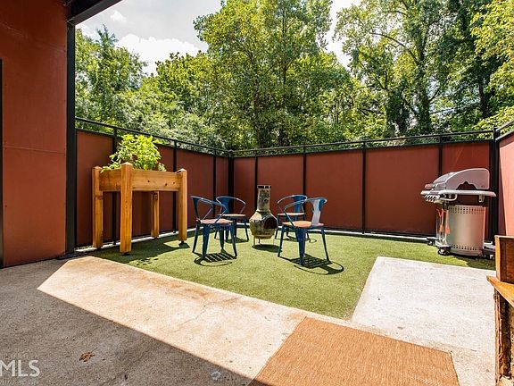 Walled courtyard on main level ready for lush landscaping