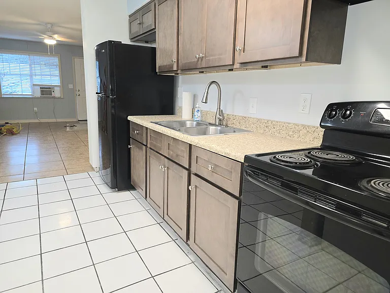 Fresh cabinets with lots of great storage, garbage disposal & electric range with range hood.