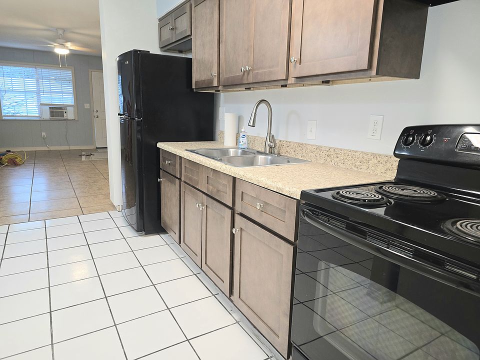 Fresh cabinets with lots of great storage, garbage disposal & electric range with range hood.