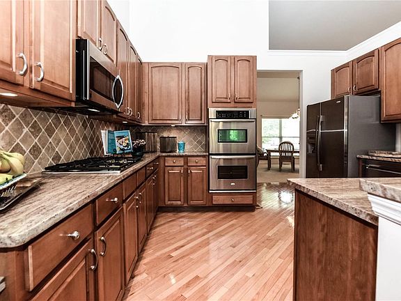 Gorgeous Granite, Stainless Steel Appliances, Gas Downdraft Cooktop, Double Ovens and Maple Cabinetry finish the wonderful kitchen!