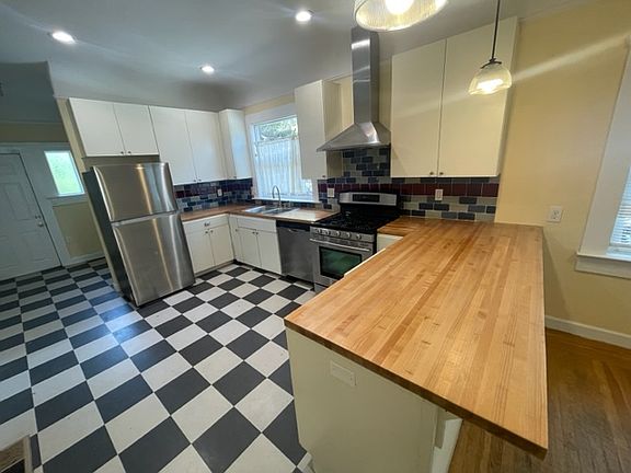 Kitchen and butcher block counter with bar seating