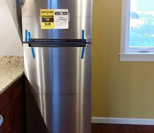 Refrigerator included in unit
