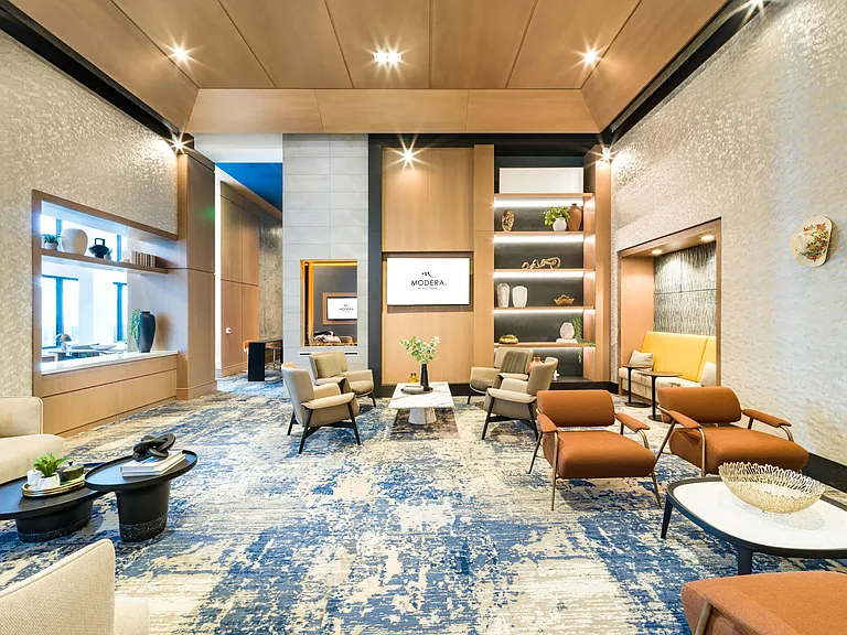 A spacious resident lounge at Modera McGavock, blending warm textures and curated seating just a short drive from Nashville's music and dining scene.