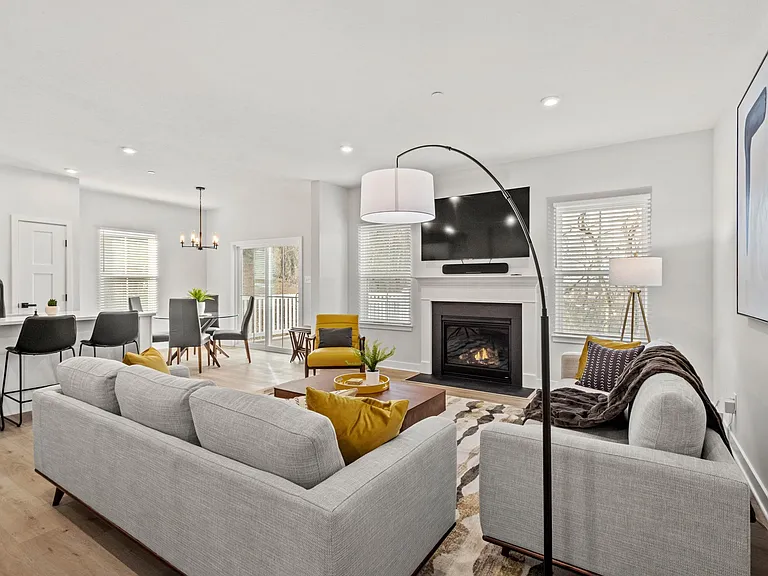Open concept great room is styled with mid-century modern decor