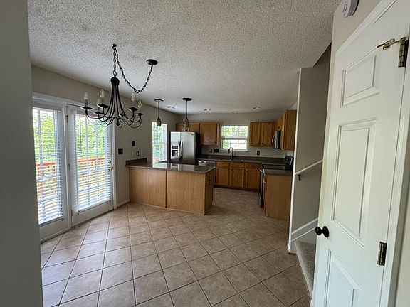 Kitchen has adjoining eat in area with French doors to deck.