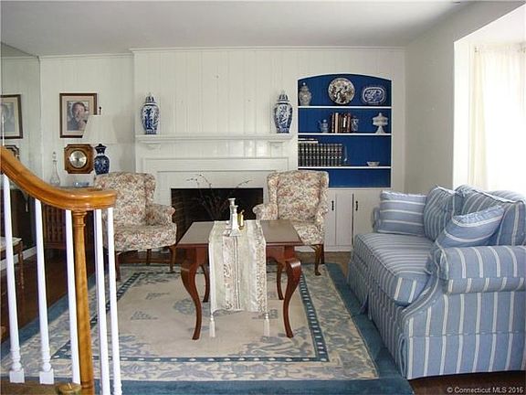 Formal Living room with built in, wood burning fire place and hardwood floors.