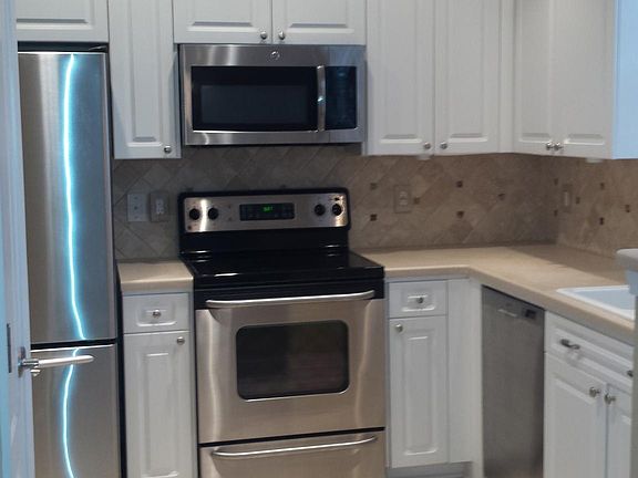 Custom stone flooring in the bright kitchen!