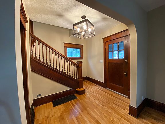 Entryway with original woodwork and hardwood floors