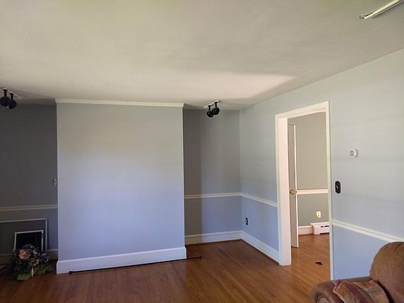 Living room, large/natural light window (not shown); hardwood floors