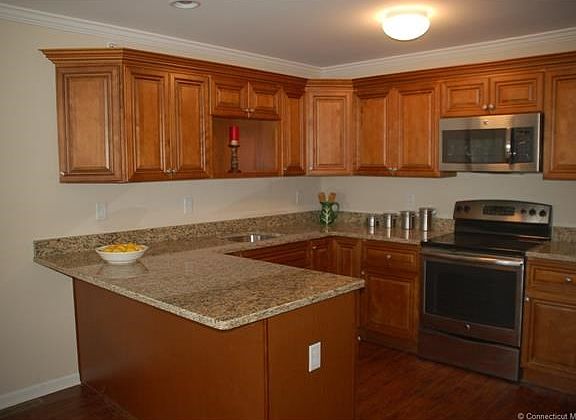 Upgraded kitchen cabinets and 10" granite overhang.
