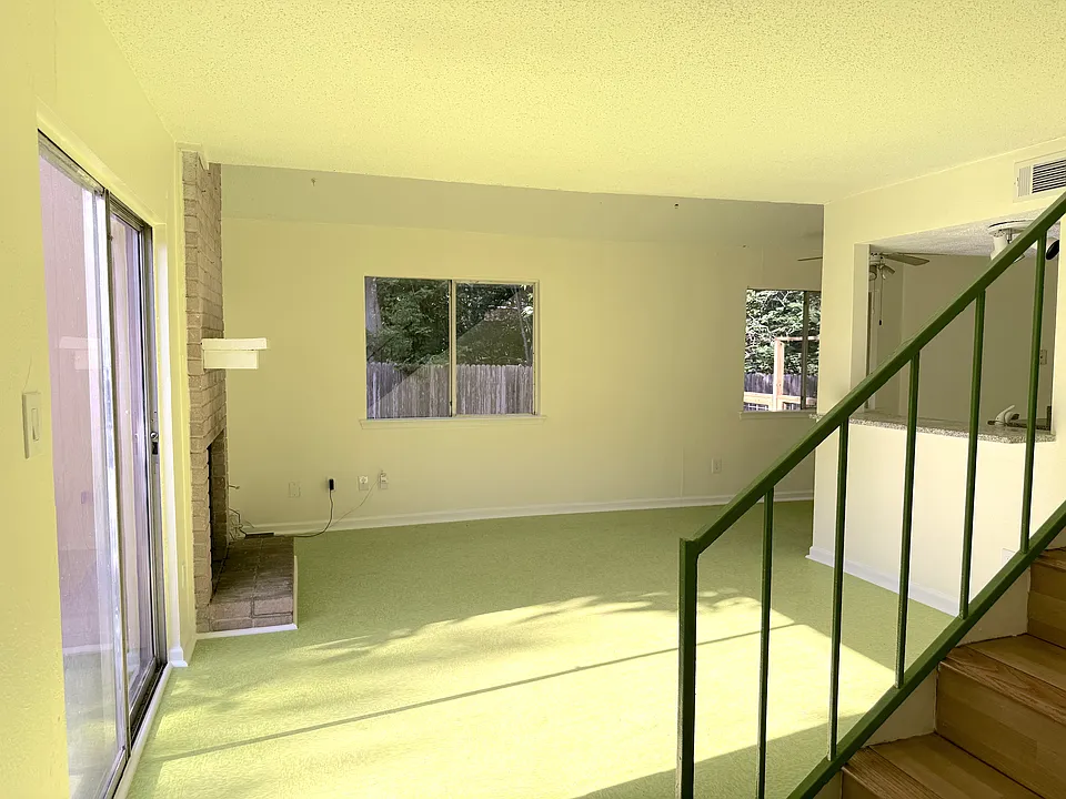 Spacious Livingroom with fireplace and patio access.