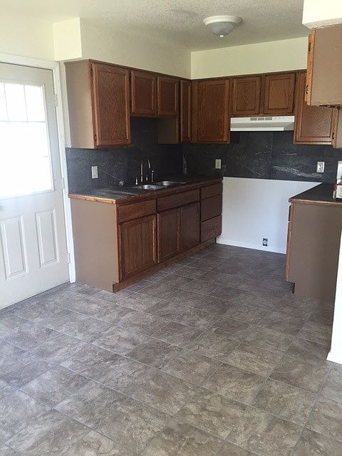 Kitchen has new tile backsplash and new stove. Fridge will b