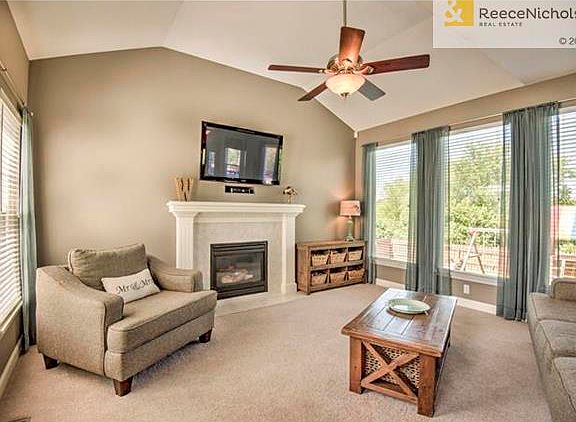 Step into the great room from the entry hall which includes a tiled fireplace with gas logs and notice the abundance of windows in this vaulted ceiling room that allow the natural sunlight to shine in.