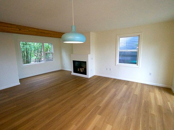 Great room with fireplace. The combined living/dining area is open to the kitchen. There's plenty of space for relaxing and daydreaming in the cozy nook by the gas fireplace. The entry area is separated by a handy closet.