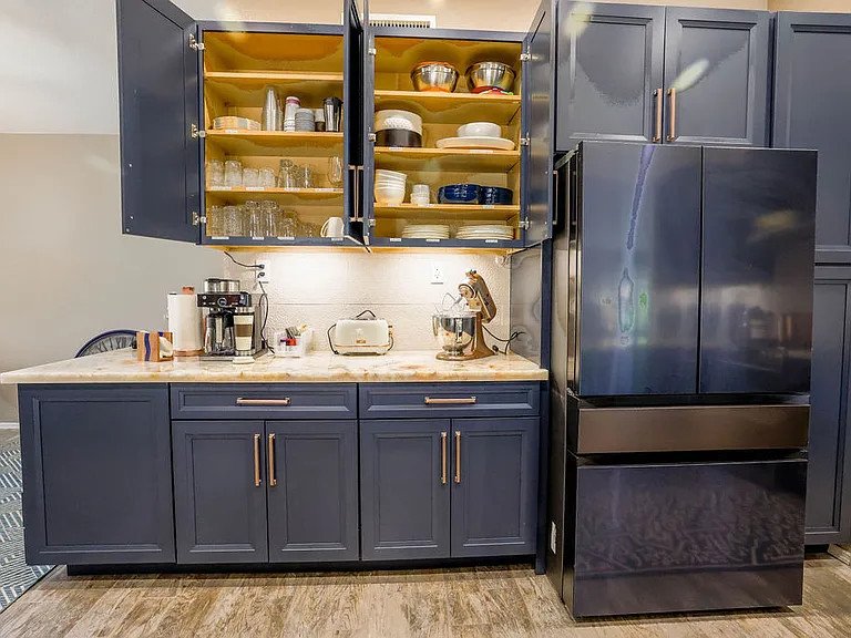 Kitchen with french style refrigerator, service for 8, serving dishes, blender/magic bullet, griddle, air fryer, Ninja coffee center, Kitchen aid mixer, toaster, microwave