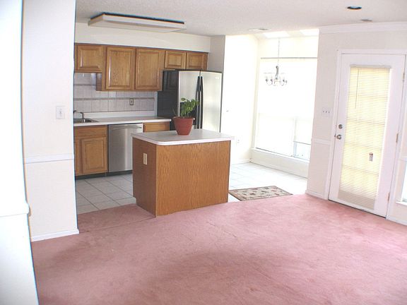 Family room off Kitchen w door leading to fenced Patio