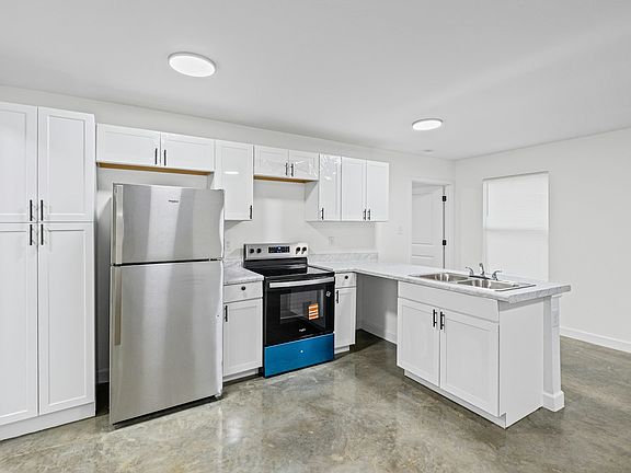 kitchen area featuring new cabinetry and a spacious layout