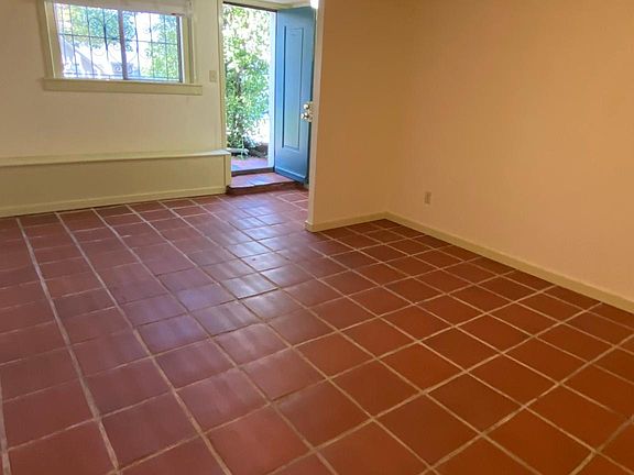 Main space from opposite direction looking towards front door and window