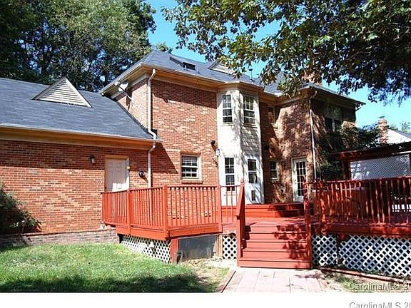 Oversized deck over looks fenced yard