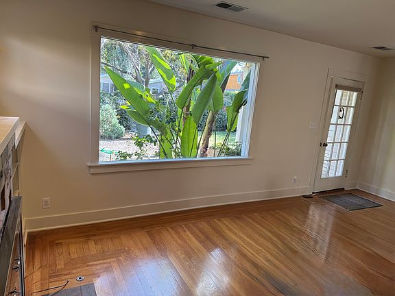 Large picture window in livingroom by glass front door
