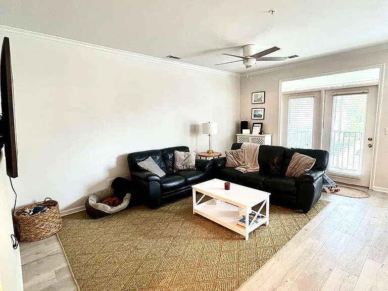 Living room, open to the kitchen. Please see additional photo for another layout a tenant could choose.