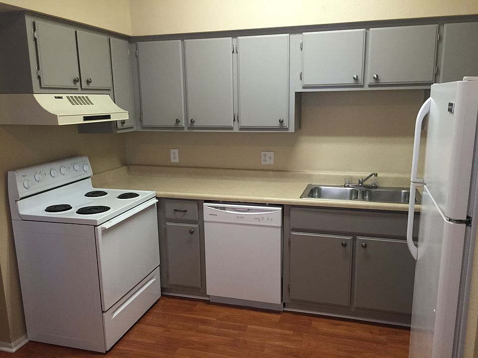 Kitchen with modern grey cabinets, white appliances