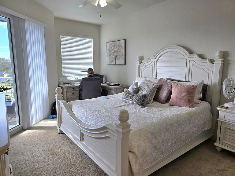 Master bedroom with access to balcony and water view. Large walk in closet.