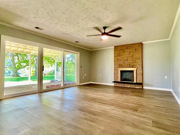 Family room with electric fireplace, opening to the Pergala and a great view of the lake 20' x 15', It has brand new Laminate Vinyl Plank flooring.