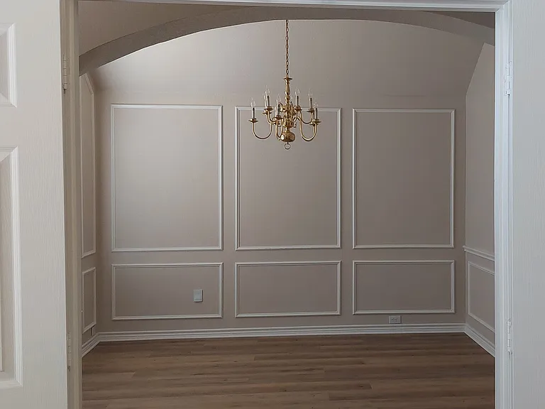 Formal dining room or living area with carpet and pictures removed, but luxury vinyl tile flooring installed 7/20/2026