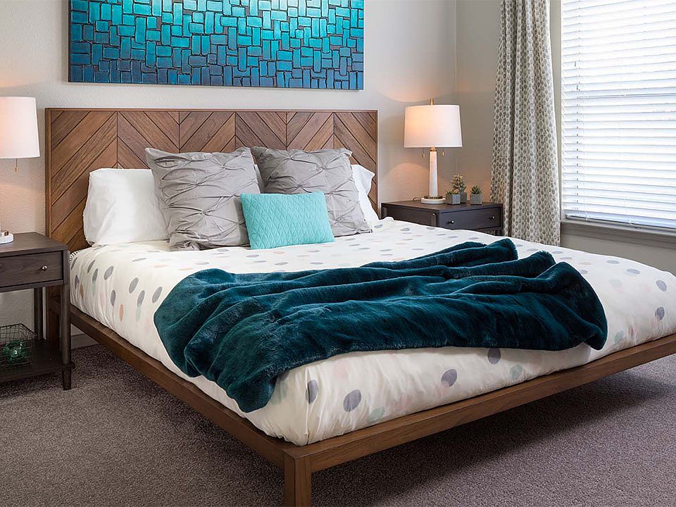 Spacious apartment bedroom with carpeted floors.