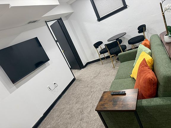 Comfortable living area with 50 inch TV and dining area.