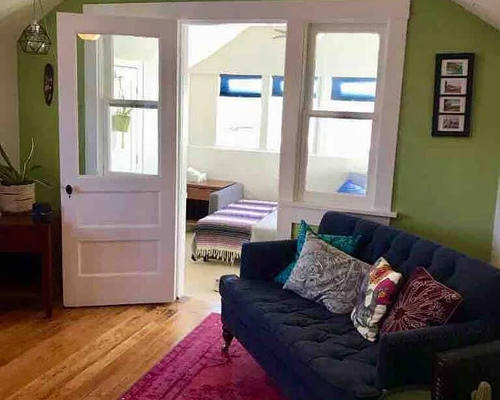 living room view, showing entrance to sun room.