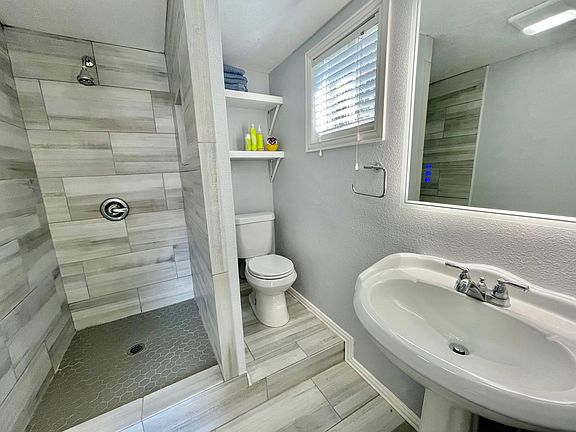 En suite bathroom with LED mirror and bidet.