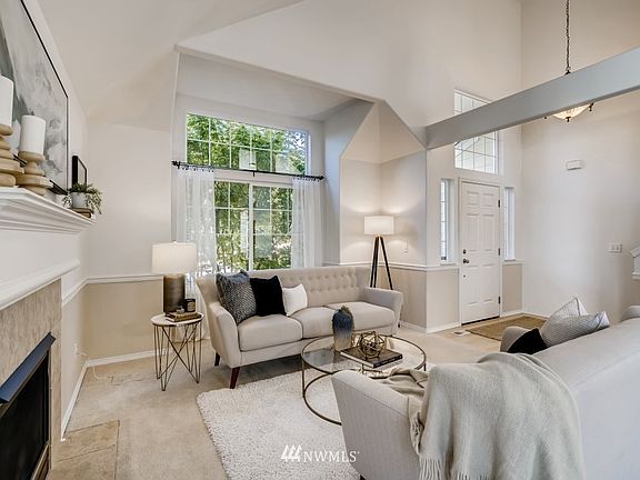 Lovely  formal living room with  fireplace and large picture window