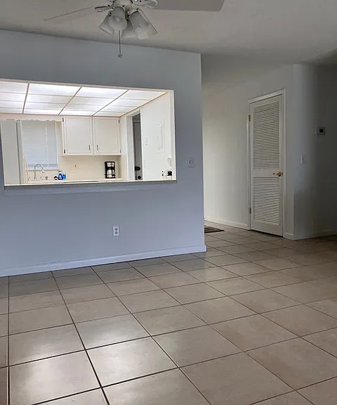 Open view of the dining room, kitchen, and entryway.
