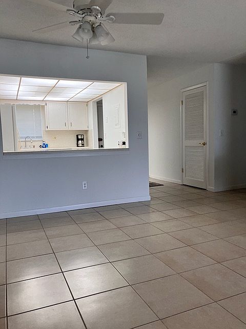 Open view of the dining room, kitchen, and entryway.