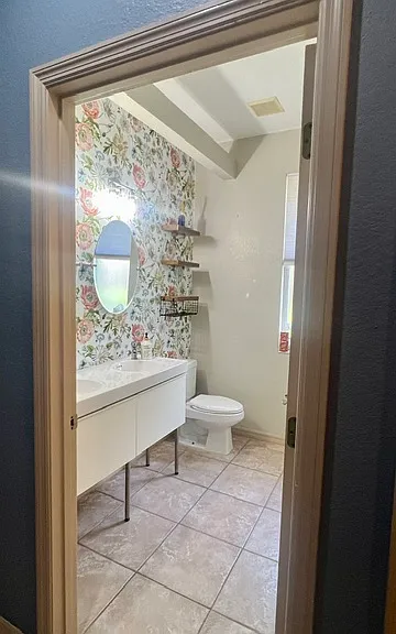 Bathroom #2: twin sinks, toilet, mirrors, lighting, bath tub/shower combination, and *shelving (*for convenience only). 2 guestrooms in this true 3 way split home share this bathroom. Ideal for siblings.
