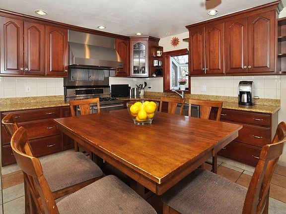 Eat in kitchen with granite countertops and stainless applia
