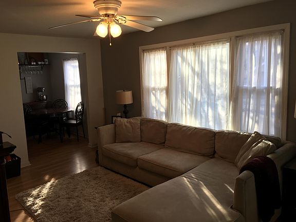 Living room from front door - They had very large furniture for the space. Curtains are theirs and we have cordless blinds now.