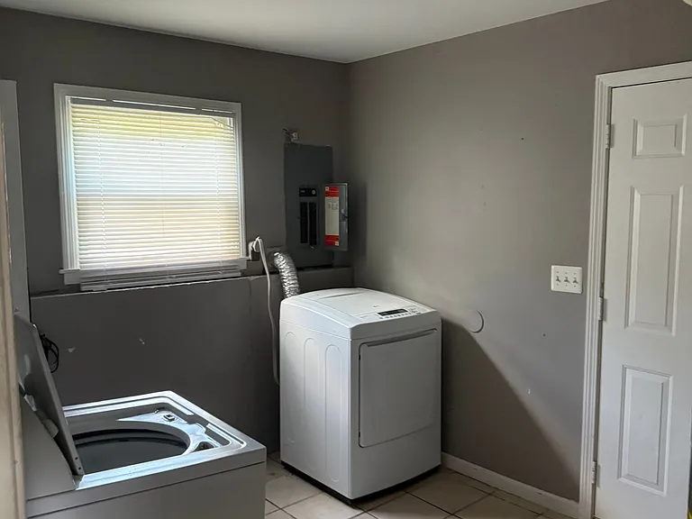 Laundry room on main floor next to garage and kitchen