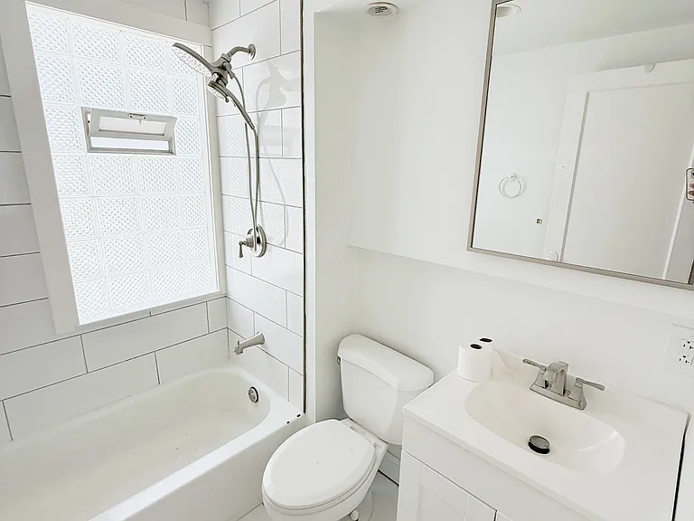 Newly renovated Bathroom features a medicine cabinet with storage, vanity with storage, a tub/shower combo, and modern lighting.