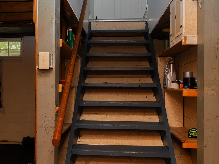 basement stairway off of kitchen and side door