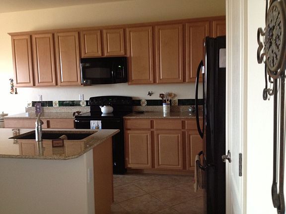 Upgraded kitchen with granite countertops, pantry and island