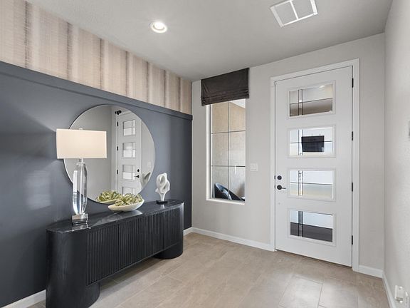 Walk in to an impressive foyer with a custom accent wall and modern front door.