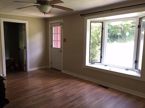 Living room with front door and door to front bedroom