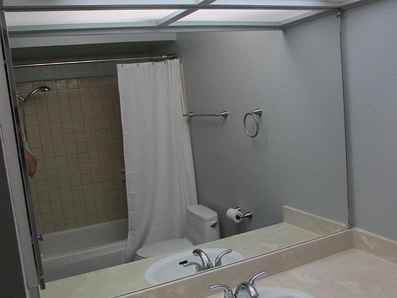 Hall bathroom/full tile shower/bath. W/D not shown to the left of image