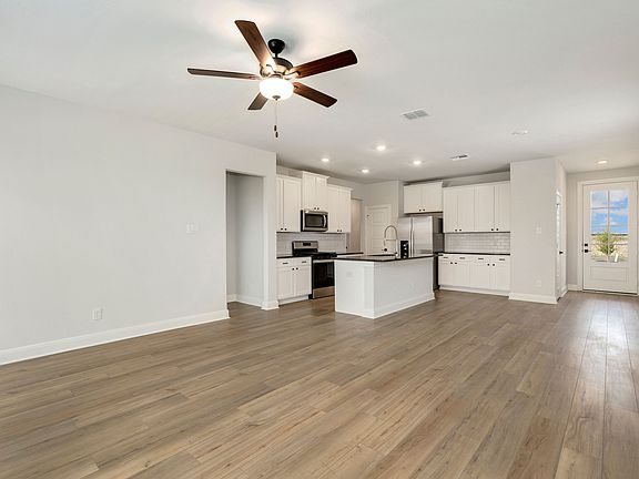Open-concept layout with the kitchen overlooking the dining area and living room.