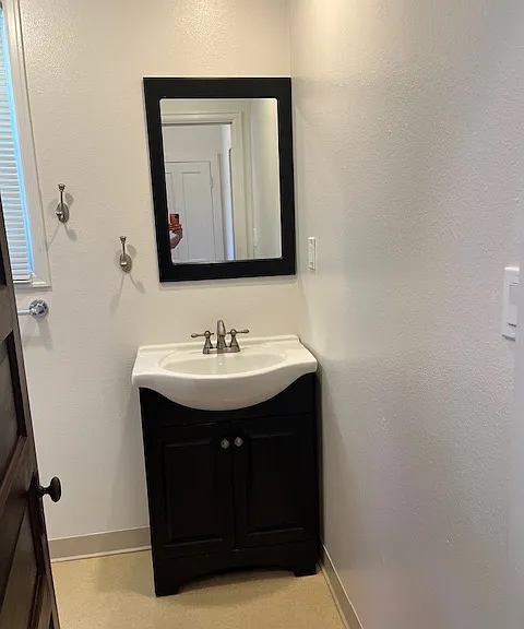bathroom sink. Large medicine cabinet above the toilet is not shown
