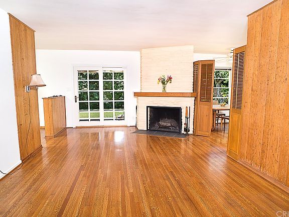 The living room with hardwood floors, fireplace an