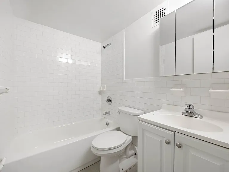 Clean and fully furnished bathroom with modern fixtures and a fresh, inviting design.